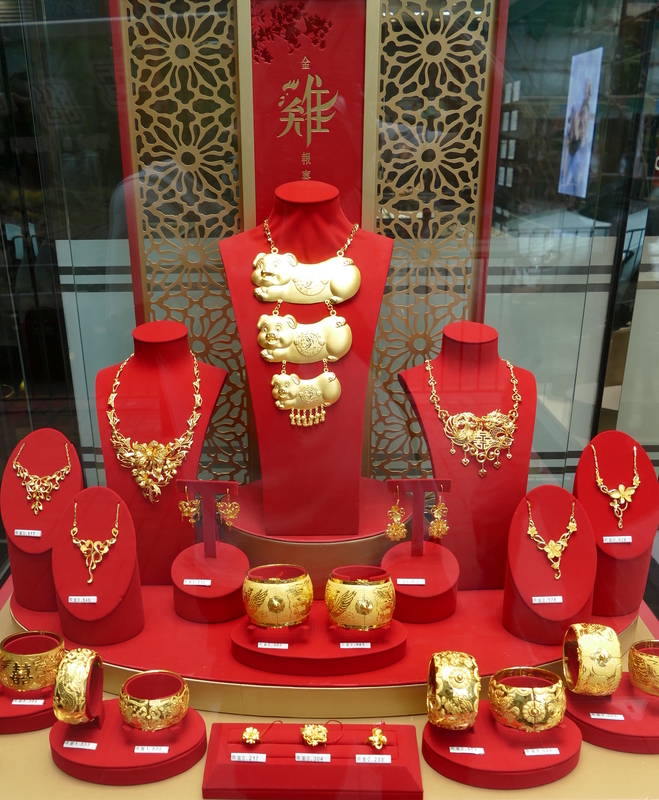 A jewelry display window, including one of the largest gold necklaces ever made by man, featuring three happy pigs*
