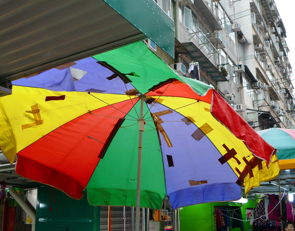 A colourful umbrella patched with tape