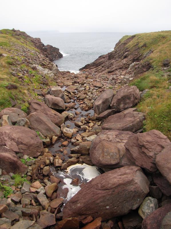 A stoney gully leading to the sea
