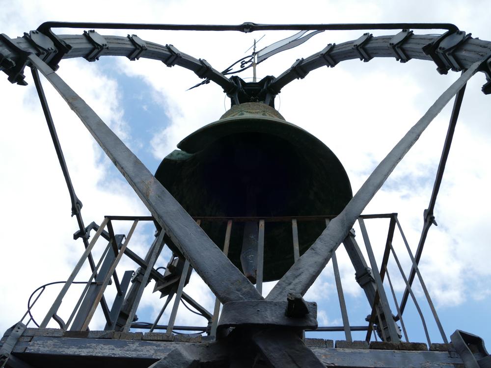 A large bell with huge metal supports
