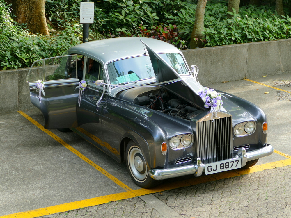Broken-down Rolls-Royce in full wedding regalia