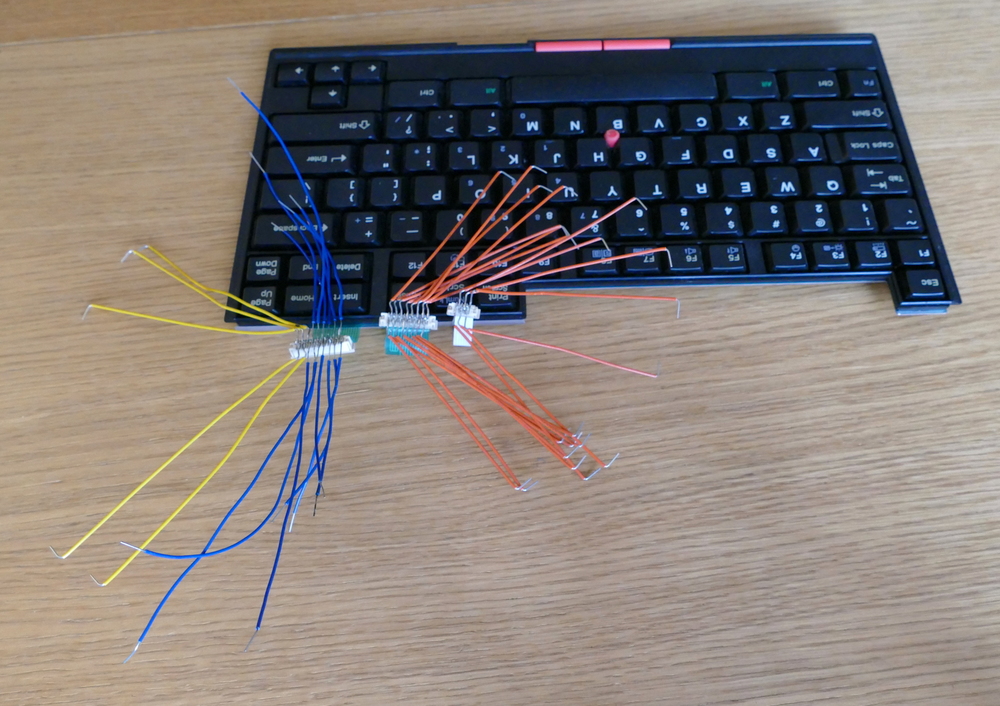 The Thinkpad keyboard with the three ribbon cable connectors, each with jumper wires sticking off in all directions