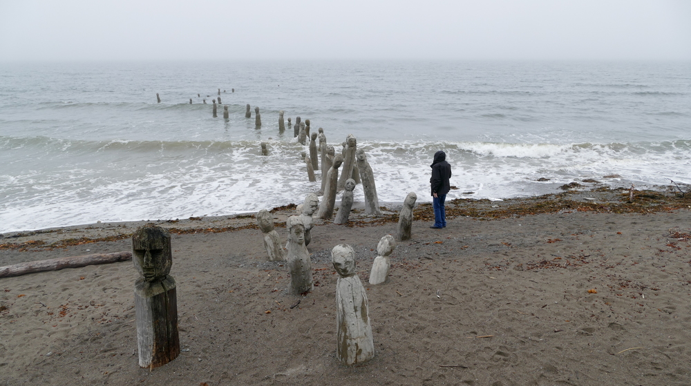 stone and wood figures emerging from the St. Lawrence onto the beach