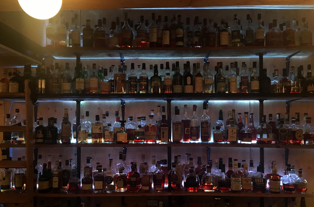 About 100 whisky bottles behind the bar at Folly