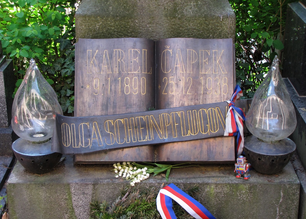 Karel Čapek's grave with red-white-and-blue ribbons and a small tin robot
