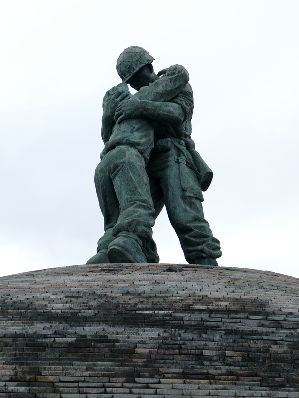 sculpture of two soldiers, one collapsed in the arms of the other