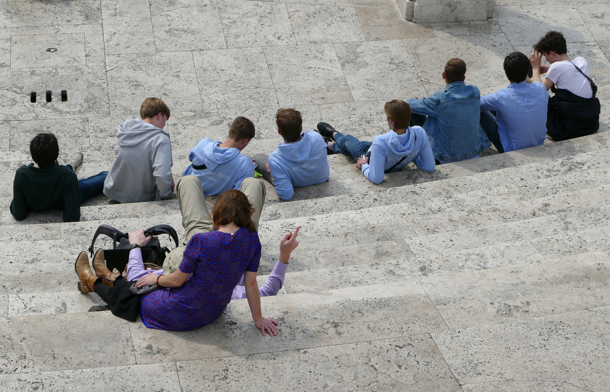 a group of people resting on the Spanish Steps, seen from above