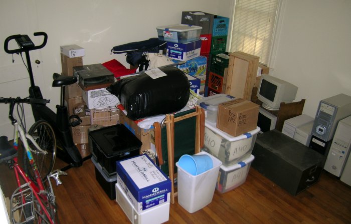 Pile of boxes, a bicycle, computers, monitors ...