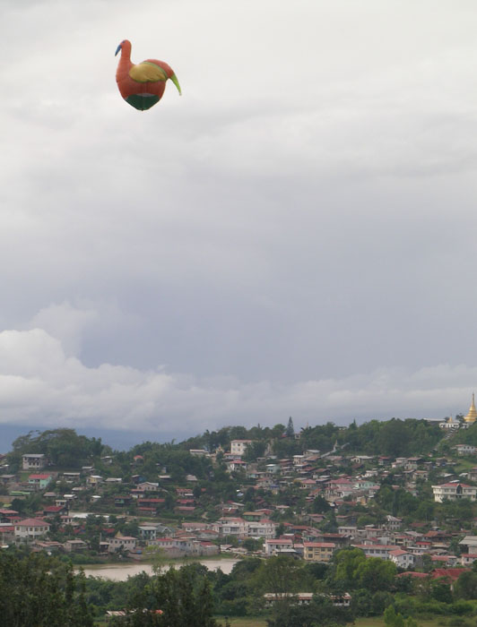 a bird-shaped balloon (the size of a small house) floating over Taunggyi, Myanmar