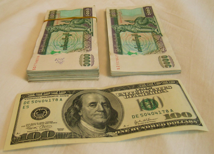 A single $100 U.S. bill and the 125 x 1000 kyat bills it buys you in Myanmar