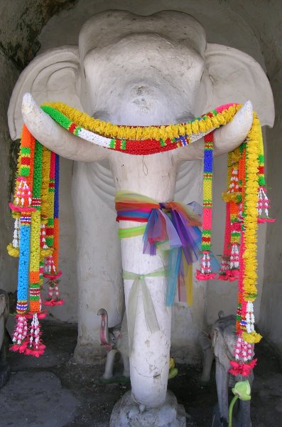 A sculpture/shrine to white elephants, the tusks and trunk colourfully decorated.