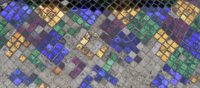 Colourful mirrored tile on concrete - a lot of the tiles have gone missing.