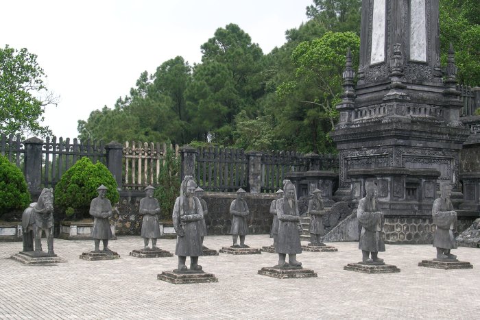 A number of stone men and a horse stand guard outside the emperor's tomb