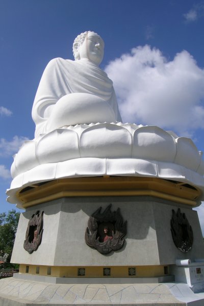 Huge white seated Buddha against the sky