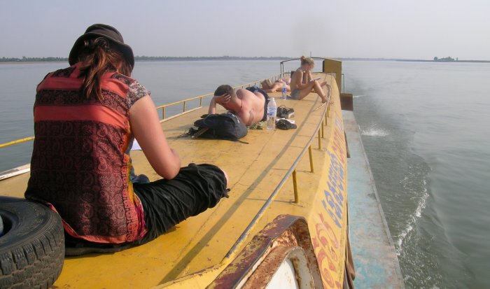Sitting on the roof of a boat headed for Cambodia