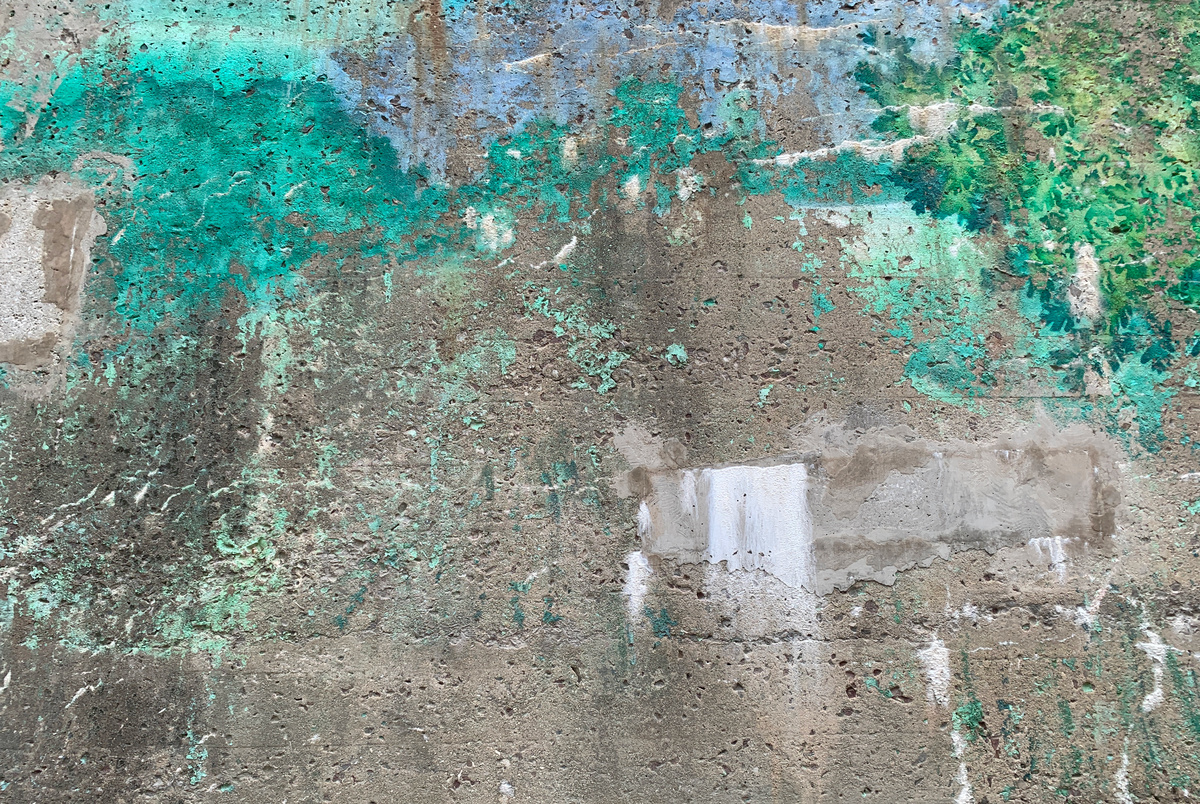some green paint stains over bare concrete