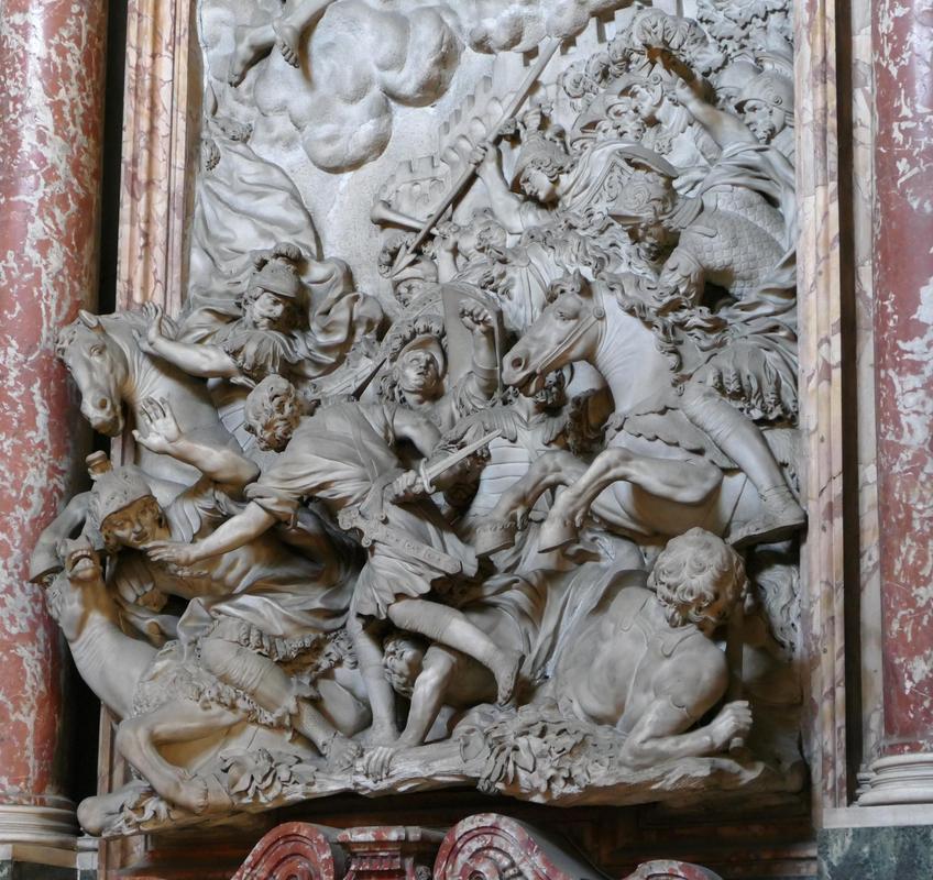 A wall sculpture at a church with a seething mass of horses and warriors.